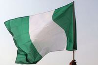 Nigerian lawyers hold up the national flag as they assemble at the secretariat of the Nigerian Bar Association during a protest in Abuja over the suspension of Chief Justice of Nigeria (CJN) in Abuja on January 28, 2019. - Nigeria's government has denied suggestions that the suspension of the country's top judge on corruption charges was linked to next month's election. President Muhammadu Buhari replaced Chief Justice Walter Onnoghen on January 25, 2019, sparking claims he had breached the constitution and was trying to manipulate the judiciary. (Photo by SODIQ ADELAKUN / AFP)SODIQ ADELAKUN/AFP/Getty Images