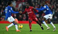 Liverpool's Guinean midfielder Naby Keita (C) vies with Everton's Nigerian midfielder Alex Iwobi (L) and Everton's French midfielder Abdoulaye Doucoure during the English Premier League football match between Liverpool and Everton at Anfield in Liverpool, north west England on February 13, 2023. (Photo by Paul ELLIS / AFP) / RESTRICTED TO EDITORIAL USE. No use with unauthorized audio, video, data, fixture lists, club/league logos or 'live' services. Online in-match use limited to 120 images. An additional 40 images may be used in extra time. No video emulation. Social media in-match use limited to 120 images. An additional 40 images may be used in extra time. No use in betting publications, games or single club/league/player publications. /  (Photo by PAUL ELLIS/AFP via Getty Images)