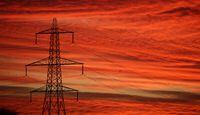 FILE PHOTO: The sun rises behind an electricity pylon in Manchester, Britain, January 18, 2022. REUTERS/Phil Noble