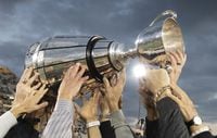 Members of the Hamilton Tiger Cats Grey Cup winning team from 1999 hoist the cup once again at centre field during a pre-game ceremony prior to CFL football game action between the Hamilton Tiger Cats and the Edmonton Eskimos in Hamilton, Ont., Friday, Oct. 4, 2019. The Grey Cup won't be presented this season, but fans will get a chance to have their name associated with the iconic trophy. THE CANADIAN PRESS/Peter Power