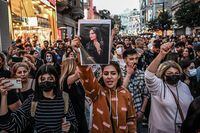 A protester holds a portrait of Mahsa Amini  during a demonstration in support of Amini, a young Iranian woman who died after being arrested in Tehran by the Islamic Republic's morality police, on Istiklal avenue in Istanbul on September 20, 2022. - Amini, 22, was on a visit with her family to the Iranian capital when she was detained on September 13 by the police unit responsible for enforcing Iran's strict dress code for women, including the wearing of the headscarf in public. She was declared dead on September 16 by state television after having spent three days in a coma. (Photo by Ozan KOSE / AFP) (Photo by OZAN KOSE/AFP via Getty Images) *** BESTPIX ***
