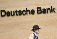 FILE PHOTO: A worker walks past Deutsche Bank offices in London, Britain, March 16, 2023. REUTERS/Toby Melville