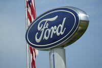 A Ford logo is seen on signage at Country Ford in Graham, N.C., Tuesday, July 27, 2021. Ford is recalling about 200,000 cars in the U.S., Wednesday, Jan. 19, 2022, to fix a problem that can stop the brake lights from turning off. The recall covers certain 2014 and 2015 Ford Fusion and Lincoln MKZ midsize cars as well as some 2015 Mustangs. (AP Photo/Gerry Broome)
