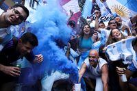 Fans react while watching the World Cup's final between Argentina and France in Sao Paulo, Brazil, on Dec. 18.