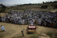 Relatives and mourners attend the funeral prayer of victims who were killed in Sunday's suicide bomber attack in the Bajur district of Khyber Pakhtunkhwa, Pakistan, Monday, July 31, 2023. Pakistan held funerals on Monday for victims of a massive suicide bombing that targeted a rally of a pro-Taliban cleric the previous day. (AP Photo/Mohammad Sajjad)