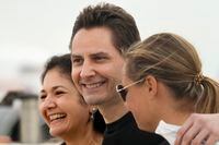 FILE - In this Sept. 25, 2021, file photo, Michael Kovrig, center, embraces his wife Vina Nadjibulla, left, and sister Ariana Botha after arriving at Pearson International Airport in Toronto. Two Canadians, Kovrig and Michael Spavor who were detained in late 2019, days after Huawei’s chief financial officer, Meng Wanzhou, was arrested in Canada at the request of U.S. authorities, have been allowed to return to Canada after being released on bail for health reasons, China's Foreign Ministry said Monday, Sept. 27, 2021. (Frank Gunn/The Canadian Press via AP)