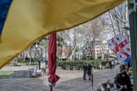 A Ukrainian flag, foreground top, flies on a street in Tbilisi, Georgia, on March 13, 2022. Russia invaded Georgia in 2008. To many Georgians, that means the country should stand unequivocally with Ukraine. But the government is more cautious. (Laetitia Vancon/The New York Times)