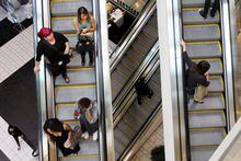 FILE PHOTO: Shoppers ride escalators at the Beverly Center mall in Los Angeles, California November 8, 2013. REUTERS/David McNew/File Photo