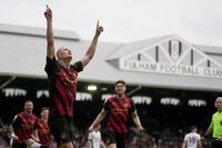 Manchester City's Erling Haaland celebrates after scoring the opening goal from the penalty spot during the English Premier League soccer match between Fulham and Manchester City at Craven Cottage in London, Sunday, April 30, 2023. City won the game 2-1. (AP Photo/Kin Cheung)