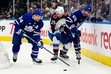 Toronto Maple Leafs' Auston Matthews (34) protects the puck as Colorado Avalanche's Logan O'Connor (25) and Maple Leafs' Mark Giordano (55) battle during first period NHL action in Toronto on Wednesday, March 15, 2023. THE CANADIAN PRESS/Frank Gunn