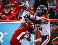 BC Lions receiver Bryan Burnham, right, goes up for a pass as Calgary Stampeders defensive back Dionte Ruffin blocks him during second half CFL football action in Calgary, Saturday, Sept. 17, 2022.THE CANADIAN PRESS/Jeff McIntosh
