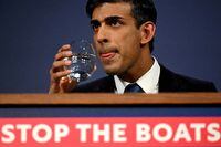 FILE PHOTO: British Prime Minister Rishi Sunak drinks water during a press conference following the launch of new legislation on migrant channel crossings at Downing Street on March 7, 2023 in London, United Kingdom. Leon Neal/Pool via REUTERS