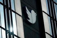 A Twitter logo hangs outside the company's offices in San Francisco, Monday, Dec. 19, 2022. (AP Photo/Jeff Chiu)