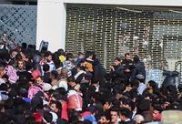 Iraqi soccer fans try to enter the Basra International Stadium in Basra, Iraq, Thursday, Jan 19, 2023. A stampede outside the stadium has killed and injured a number of people. (AP Photo/Anmar Khalil)