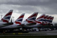 FILE PHOTO: The tail fins of British Airways planes are seen near Terminal 5 at Heathrow Airport in London, Britain March 14, 2020. REUTERS/Simon Dawson/File Photo