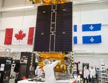 Technicians put the final touches on the second of three Radarsat Constellation Mission satellites at the MDA facility Thursday, June 21, 2018 in Montreal. The satellites, which will be launched in late 2018, will be doing Maritime surveillance, ecosystem monitoring and disaster management. THE CANADIAN PRESS/Ryan Remiorz