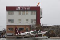 A preliminary report by the Transportation Safety Board of Canada says a plane that crashed in the Northwest Territories this week was chartered to help with winter road construction in the area. An Air Tindi float base is shown in Yellowknife on Tuesday, Oct. 4, 2011.THE CANADIAN PRESS/James Mackenzie