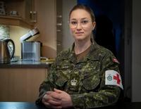 Warrant Officer Josee Payeur, a Canadian Forces Medical Technician, poses for a portrait at her home in Longueuil, Que., Monday, Feb. 7, 2022. When Payeur joined the Canadian Armed Forces in 2001, she felt that people who occasionally used the unofficial feminine version of her rank when addressing her in French were trying to belittle her. THE CANADIAN PRESS/Peter McCabe