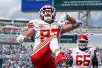 Kansas City Chiefs tight end Travis Kelce (87) celebrates his touchdown by kicking a ball into the stands during an NFL football game against the Jacksonville Jaguars, Sunday, Sept. 17, 2023, in Jacksonville, Fla. The Chiefs defeated the Jaguars 17-9. (AP Photo/Gary McCullough)