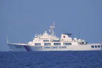 In this photo provided by the Philippine Coast Guard, a Chinese Coast Guard vessel is seen patrolling in the South China Sea, taken sometime April 13-14, 2021. Chinese coast guard ships blocked and used water cannons on two Philippine supply boats heading to a disputed shoal occupied by Filipino marines in the South China Sea, provoking an angry protest against China and a warning from the Philippine government that its vessels are covered under a mutual defense treaty with the U.S., Manila’s top diplomat said Thursday, Nov. 18, 2021. (Philippine Coast Guard via AP)