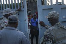 Dominican Republic soldiers close a border gate on a Haitian man who was hoping to cross into Dajabon, Dominican Republic, Friday, Nov. 19, 2021. A group in Haiti that supports people sent home from the neighbouring Dominican Republic is calling on Canada to raise the alarm about accusations of inhumane and racist treatment of those fleeing chaos. THE CANADIAN PRESS/AP-Matias Delacroix
