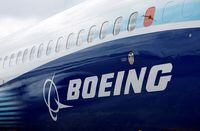FILE PHOTO: FILE PHOTO: The Boeing logo is seen on the side of a Boeing 737 MAX at the Farnborough International Airshow, in Farnborough, Britain, July 20, 2022.  REUTERS/Peter Cziborra/File Photo/File Photo
