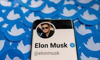 FILE PHOTO: Elon Musk's Twitter profile is seen on a smartphone placed on printed Twitter logos in this picture illustration taken April 28, 2022. REUTERS/Dado Ruvic/Illustration