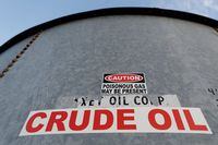 FILE PHOTO: A sticker reads crude oil on the side of a storage tank in the Permian Basin in Mentone, Loving County, Texas, U.S. November 22, 2019. REUTERS/Angus Mordant