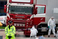 In this Oct. 23, 2019, file photo, forensic police officers are on scene after 39 bodies were found in a truck in Grays, South England.