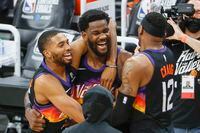 PHOENIX, ARIZONA - JUNE 22: Deandre Ayton #22 of the Phoenix Suns, Torrey Craig #12, and Mikal Bridges #25 celebrate defeating the LA Clippers 104-103 in game two of the NBA Western Conference finals at Phoenix Suns Arena on June 22, 2021 in Phoenix, Arizona. NOTE TO USER: User expressly acknowledges and agrees that, by downloading and or using this photograph, User is consenting to the terms and conditions of the Getty Images License Agreement.  (Photo by Christian Petersen/Getty Images)