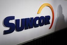 A Suncor logo is shown at the company's annual meeting in Calgary, Thursday, May 2, 2019. Suncor on Thursday said is would lay off 1,500 workers by the end of 2023. THE CANADIAN PRESS/Jeff McIntosh