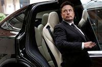 Tesla Chief Executive Officer Elon Musk gets in a Tesla car as he leaves a hotel in Beijing, China May 31, 2023. REUTERS/Tingshu Wang