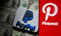 FILE PHOTO: A Pinterest logo is seen on a smartphone placed over U.S. dollar banknotes and a 3D printed PayPal logo in this illustration taken October 20, 2021. REUTERS/Dado Ruvic/Illustration/File Photo