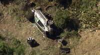 In this aerial image take from video provided by KABC-TV video, a vehicle rest on its side after a rollover accident involving golfer Tiger Woods along a road in the Rancho Palos Verdes section of Los Angeles on Tuesday, Feb. 23, 2021. Woods had to be extricated from the vehicle with the "jaws of life" tools, the Los Angeles County Sheriff's Department said in a statement. Woods was taken to the hospital with unspecified injuries. The vehicle sustained major damage, the sheriff's department said. (KABC-TV via AP)