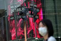 A woman wearing a protective mask stands in front of an electronic stock board showing Japan's Nikkei 225 index Monday, May 30, 2022, in Tokyo. Asian stocks rose Monday after Wall Street rebounded from a seven-week string of declines and China eased anti-virus curbs on business activity in Shanghai and Beijing. (AP Photo/Eugene Hoshiko)