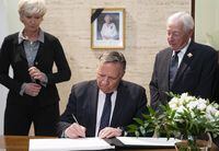 Quebec Premier Francois Legault signs the condolence book dedicated to Queen Elizabeth II witnessed by Lieutenant Governor of Quebec, Michel Doyon and wife Isabelle Brais in Quebec City, Friday, Sept. 9, 2022. THE CANADIAN PRESS / Karoline Boucher