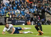 D.C. United's Steve Birnbaum goes down as CF Montreal's Kei Kamara watches the ball during second half MLS action in Montreal on Saturday, October 1, 2022. THE CANADIAN PRESS/Peter McCabe