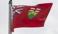 Ontario's provincial flag flies in Ottawa, Monday, July 6, 2020. Some Ontario workers will see their paycheques rise this week as the province increases its minimum wage today. THE CANADIAN PRESS/Adrian Wyld