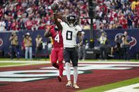 Jacksonville Jaguars wide receiver Calvin Ridley (0) celebrates after catching a touchdown pass as Houston Texans' Tavierre Thomas (4) looks on in the second half of an NFL football game in Houston, Sunday, Nov. 26, 2023. (AP Photo/Eric Gay)