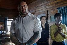 This image released by Universal Pictures shows Dave Bautista, from left, Abby Quinn, and Nikki Amuka-Bird in a scene from "Knock at the Cabin." (Universal Pictures via AP)