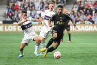 Apr 5, 2023; Vancouver, British Columbia, CAN;  Los Angeles FC forward Denis Bouanga (99) controls the ball against Vancouver Whitecaps FC midfielder Andres Cubas (20) during the second half at BC Place. Mandatory Credit: Anne-Marie Sorvin-USA TODAY Sports