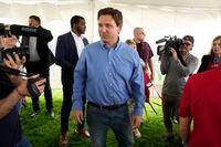 Florida Gov. Ron DeSantis talks with local residents during a fundraising picnic for U.S. Rep. Randy Feenstra, R-Iowa, Saturday, May 13, 2023, in Sioux Center, Iowa. (AP Photo/Charlie Neibergall)