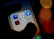 FILE PHOTO: The logos of mobile apps, Google, Amazon, Facebook, Apple and Netflix, are displayed on a screen in this illustration picture taken December 3, 2019. REUTERS/Regis Duvignau/