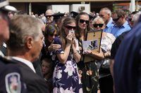 Megan, the widow of NSW Rural Fire Service (RFS) volunteer firefighter Samuel McPaul, wipes away tears as she watches the casket being loaded into the hearse during McPaul's funeral at Holbrook Sports Stadium in Albury, NSW, Australia, January 17, 2020.