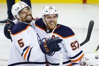 Edmonton Oilers centre Connor McDavid, right, celebrates his goal with teammate defenceman Cody Ceci after defeating the Calgary Flames in overtime NHL second-round playoff hockey action in Calgary, Thursday, May 26, 2022.THE CANADIAN PRESS/Jeff McIntosh