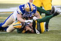 Winnipeg Blue Bombers Jake Thomas (95) sacks Edmonton Elks quarterback Taylor Cornelius (15) during first half CFL action in Edmonton, Alta., on Friday July 22, 2022. The Blue Bombers, who host the B.C. Lions (12-6) in the West Division final at IG Field this Sunday, often refer to the team’s special culture and how they’re like a family. THE CANADIAN PRESS/Jason Franson.