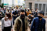 Pro-democracy activists Ivan Lam, Joshua Wong and Agnes Chow arrive at the West Kowloon Magistrates' Courts to face charges related to illegal assembly stemming from 2019, in Hong Kong on Nov. 23, 2020.