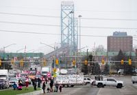 Truckers and supporters block the access leading from the Ambassador Bridge, linking Detroit and Windsor, as truckers and their supporters continue to protest against COVID-19 vaccine mandates and restrictions, in Windsor, Ont., Thursday, Feb. 10, 2022. THE CANADIAN PRESS/Nathan Denette