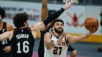 Denver Nuggets' Jamal Murray (27) drives to the basket against Cleveland Cavaliers' Cedi Osman (16) during the second half of an NBA basketball game, Friday, Feb. 19, 2021, in Cleveland.