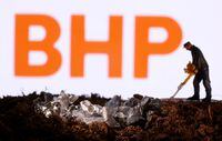 FILE PHOTO: A small toy figure and mineral imitation are seen in front of the BHP logo in this illustration taken November 19, 2021. REUTERS/Dado Ruvic/Illustration